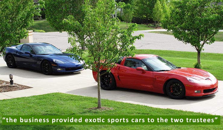 Image of two sports cars in a circular driveway