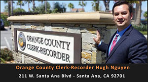 orange county clerk-recorder standing by sign